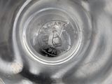 a close up of a glass with a coin inside of it