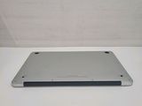 the back of a silver laptop computer sitting on top of a white table