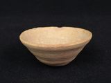 an old wooden bowl sitting on top of a black surface