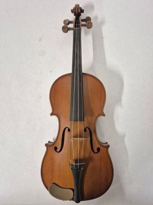 an old violin hanging on a wall next to a white wall