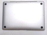 the back of a silver laptop computer sitting on top of a white table