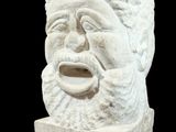 a statue of a man with a beard on a black background