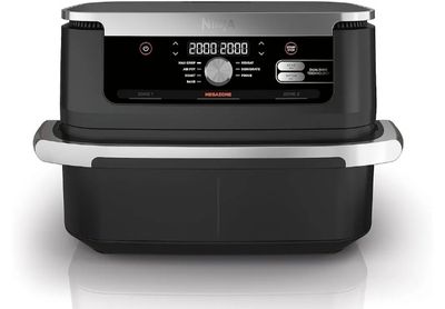 a black and silver air fryer sitting on top of a counter