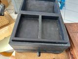 a wooden box with three compartments on top of a table