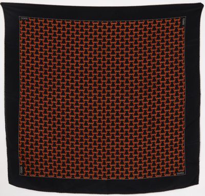 an orange and black square scarf with a black border