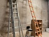 two ladders leaning against a wall in a room