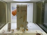a display of jewelry on display in a glass case