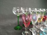 many wine glasses lined up on a table