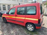 a red van that is parked in front of a house