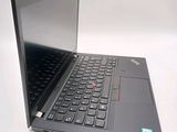 a laptop with a black keyboard on a white surface