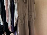 clothes hanging on a rack in a room with a red carpet