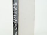 the book is sitting on a white surface with a black and white cover