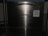 an image of a stainless steel dishwasher in a dark room