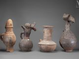 several vases are lined up in a row on a gray surface
