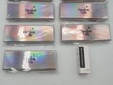 five different colors of silver foil on a white surface