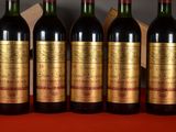 four bottles of wine are lined up on a table