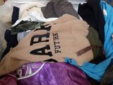 a suitcase filled with clothes and a sweater that says aff