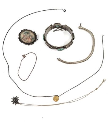 an assortment of jewelry including a necklace, bracelet, and broochet