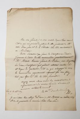 a piece of paper with writing on it sitting on top of a table