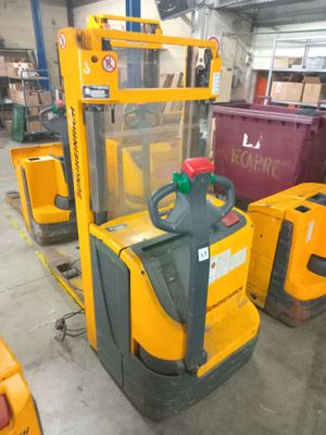 a forklift with a container on it in a warehouse