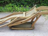 a wooden chair that is sitting in the middle of the street