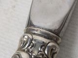 a silver spoon with a silver handle on a table