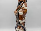a close up of a figurine of a man with a hat on