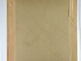 painting on a wooden easel in front of a white curtain