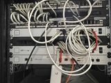 a rack with wires and a remote control in it