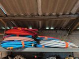 many different colored hoses on a shelf in a garage