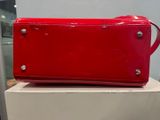 red purse on top of a white box in a room