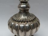 an image of a silver vase sitting on top of a table