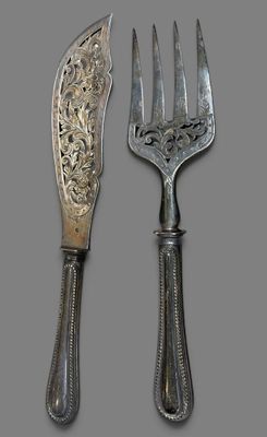 two forks and a knife on a gray background