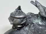 a statue of a bird sitting on top of a shoe