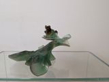 a glass table with a glass vase on top of it