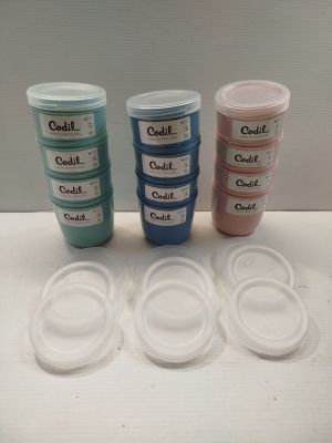 four plastic containers with labels on them are sitting on a table
