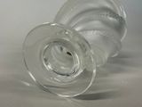 a clear glass cup with a lid sitting on a table