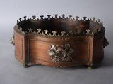an image of a wooden box with metal decorations on top of it