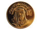 pièce d'or à l'effigie d'un homme portant un foulard