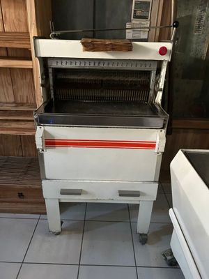 une cuisinière blanche ornée d'une bande rouge, dans une cuisine