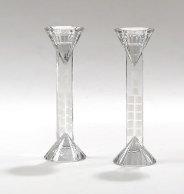 pair of clear glass candlesticks sitting on a white surface