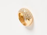 a close up of a gold ring with diamonds on a white surface