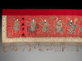 a red table runner with a picture of a group of people on it