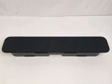 a close up of a black speaker on a white surface