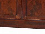 a wooden cabinet with two doors on the top of it