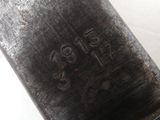 a close up of a metal object with writing on it