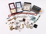 a lot of jewelry sitting on a white surface