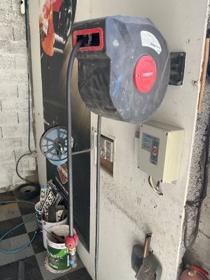 an image of a garage with a water heater and a checkered floor