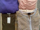 three women ' s clothing sitting on a chair on a wooden floor
