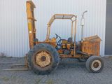a tractor that is parked in front of a building